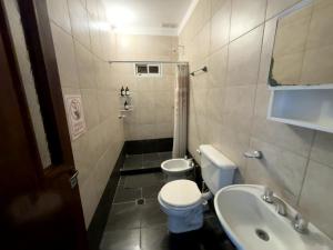 a small bathroom with a toilet and a sink at Tu casa en Ruta 34 - Wifi - Cochera -5 personas in Fernández +25 photos