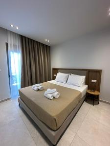 a bedroom with a bed with towels on it at 2BR Apartment for 5 in Archangelos Rhodes with Parking - Equus Sky in Archangelos