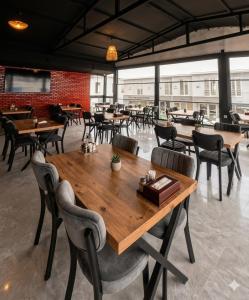 a dining room with wooden tables and chairs at Mustafa Hotel Restaurant in Pamukkale