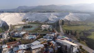 an aerial view of a town in front of a mountain at Mustafa Hotel Restaurant in Pamukkale
