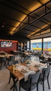 a restaurant with wooden tables and chairs and windows at Mustafa Hotel Restaurant in Pamukkale +2 photos