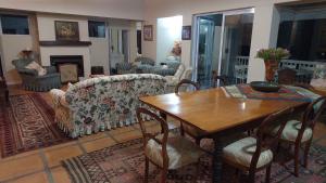 a living room with a table and a couch at Restio in Agulhas