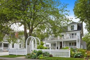 a white house with a white picket fence at Stars And Stripes in Kennebunkport