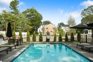 a swimming pool in a yard with a fence at Stars And Stripes in Kennebunkport