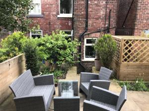 a patio with chairs and a table and a building at Stunning 3 bed house by Endcliffe Park in Nether Edge