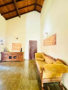 a living room with a couch and a table at Sunset Point Beachfront Villa & Restaurant in Negombo