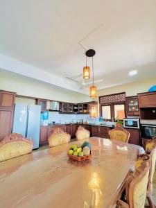 a kitchen with a table with a bowl of fruit on it at Sunset Point Beachfront Villa & Restaurant in Negombo
