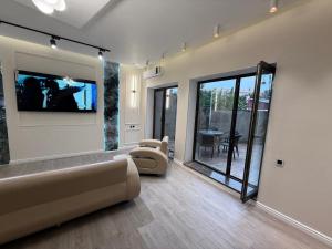 a living room with a couch and a tv at Modern Villa in Quba City Center in Quba