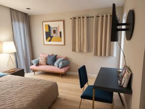 a bedroom with a bed and a couch and a table at Stylish 2, 3 and 5 Bedroom Entire Homes Near Art Deco and LA Hotspots in Los Angeles
