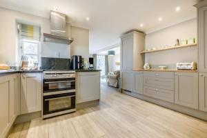 a kitchen with white cabinets and a stove top oven at 3 Bed in Knapton oc-1191 in Knapton