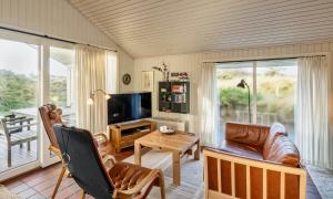 a living room with a couch and a table at VE465-Vejers-Strand-Violvej-1A in Vejers Strand