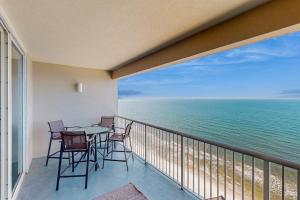 a balcony with a table and chairs and the ocean at Palazzo 1304 in Panama City Beach