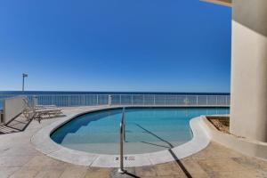 a swimming pool with the ocean in the background at Palazzo 1304 in Panama City Beach +23 photos