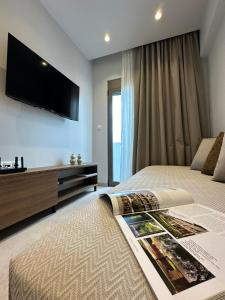 a bedroom with a bed with a tv on the wall at 2BR Apartment for 5 in Archangelos Rhodes with Parking - Equus Sky in Archangelos