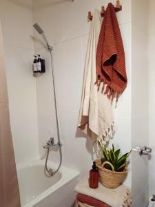 a bathroom with a shower and a toilet and a towel at La Locana in Bubión +56 photos