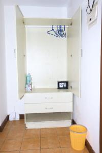 a room with a white dresser with a clock on it at Emeli apartments in Nairobi