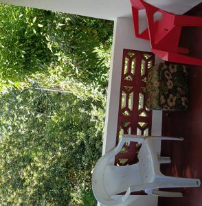 a chair sitting on a porch next to a window at Cocoa Cabana in Scarborough