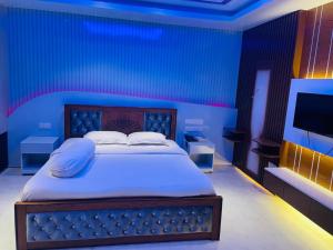 a bedroom with a bed in a blue room at Rainbow Guest House in Sylhet