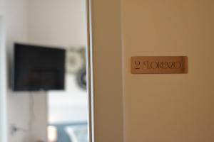 a door with a sign that reads followers at Il Ninfeo in Volta Mantovana
