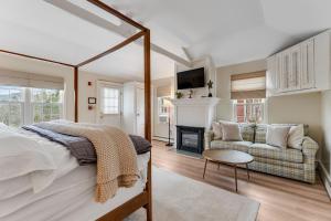 a bedroom with a bed and a fireplace and a couch at Red Clover Inn in Mendon
