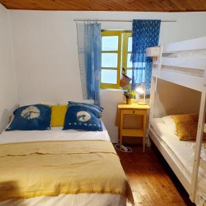 a bedroom with two bunk beds and a window at Gîte à Florac "Les Rêves Bleus" in La Salle-Prunet