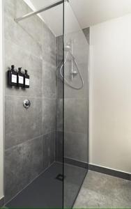 a shower with a glass door in a bathroom at Il Ninfeo in Volta Mantovana +82 photos