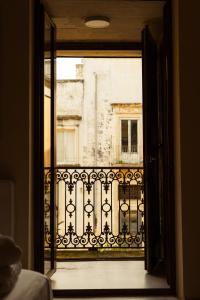 an open door to a balcony with a building at Blu Rooms in Galatina