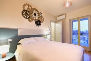 a bedroom with a large bed and a clock on the wall at Il Ninfeo in Volta Mantovana