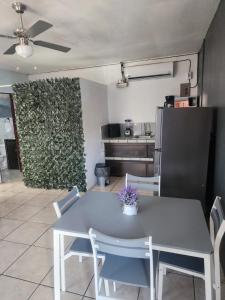 a dining room with a table and chairs and a wall at Quepos Explorers Hub Spacious Apartment in Quepos
