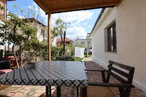 a patio with a table and chairs on a patio at Elbasan Backpacker Hostel in Elbasan