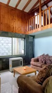 a living room with a couch and a table at Loft Central in Coihaique