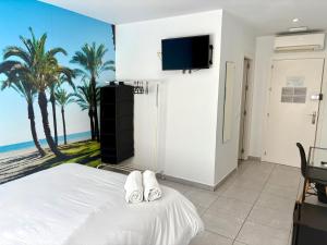 a bedroom with a bed with a view of the beach at SolRoom (plz. La Nogalera) in Torremolinos