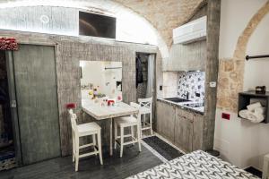 a kitchen with a table and chairs in a room at Vico Santa Maria in Putignano +43 photos