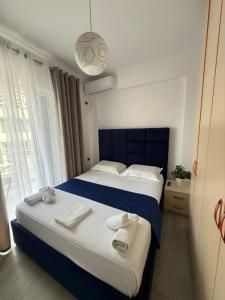 a bedroom with two beds with towels on them at Luxury Room's by Lika in Sarandë