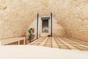 a room with a door in a stone wall at Vico Santa Maria in Putignano