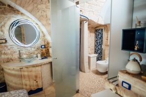 a bathroom with a sink and a mirror at Vico Santa Maria in Putignano
