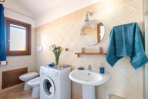 a bathroom with a washing machine and a sink at Ri Ale Sa prassa Sardegna Ogliastra in Bari Sardo +46 photos