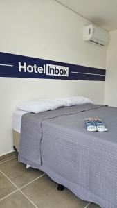 a bed in a room with a hotelipedia sign on the wall at Hotel In Box - Roseira in Roseira