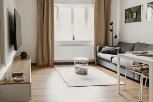 a living room with a couch and a table at Apartmány park in Poděbrady