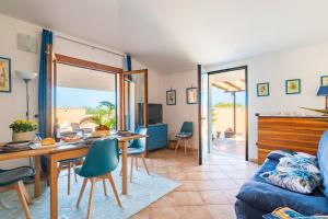 a living room with a table and a couch at Ri Ale Sa prassa Sardegna Ogliastra in Bari Sardo