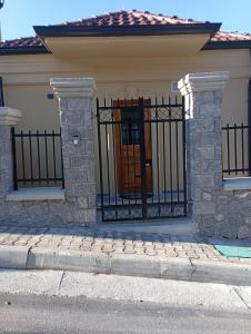 a house with a wrought iron gate on a street at Vila 76 Belvedere in Korçë