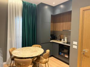 a kitchen and dining room with a table and chairs at Vila 76 Belvedere in Korçë