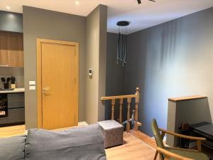 a living room with a couch and a kitchen at Vila 76 Belvedere in Korçë +3 photos