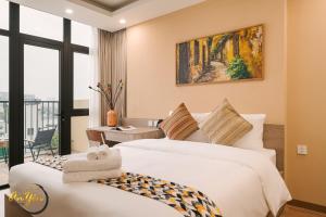 a hotel room with two beds and a balcony at An Yên Island - Art Boutique Stay with Dual Lake view in Hanoi