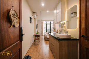 a bathroom with a sink and a large mirror at An Yên Island - Art Boutique Stay with Dual Lake view in Hanoi +73 photos