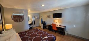 a living room with a couch and a desk at Super 8 by Wyndham Sonora in Sonora