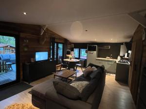 a living room with a couch and a table and a kitchen at La Luna in Lanaken