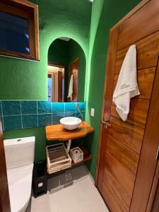 a bathroom with a sink and a toilet and a mirror at Casa Floratta - Flecheiras in Flecheiras +13 photos