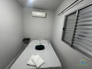 a small room with a bed and a window at Pousada Chácara Sonho in Hortolândia +54 photos