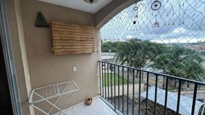 a room with a balcony with a large glass window at Apartamento completo no Planalto in Belo Horizonte
